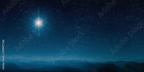 Leinwand Poster The star shines over the manger of christmas of Jesus Christ.