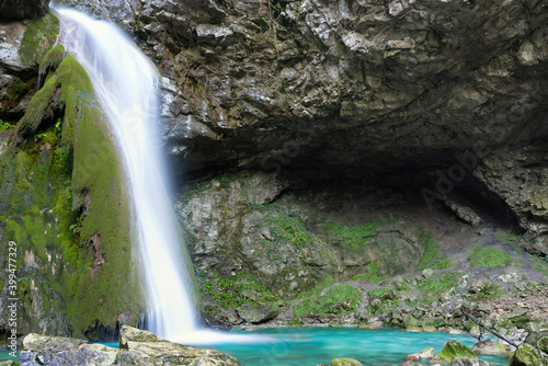 Fototapeta Naklejka Na Ścianę i Meble -  Beautiful waterfall falling from a rock covered by moss. Kot waterfall, San Leonardo, Cividale del Friuli, Udine province, Friuli Venezia Giulia region, Italy. Valli del Natisone nature.