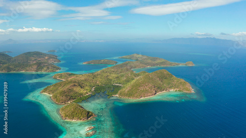 aerial view tropical islands with blue lagoons, coral reef and sandy beach. Palawan, Philippines. Islands of the Malayan archipelago with turquoise lagoons.