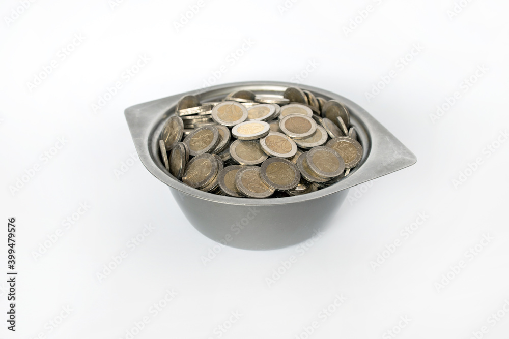 Dirty coins in a metal bowl. White background. Lithuanian money Dirty coins in a metal bowl. White background. Lithuanian money