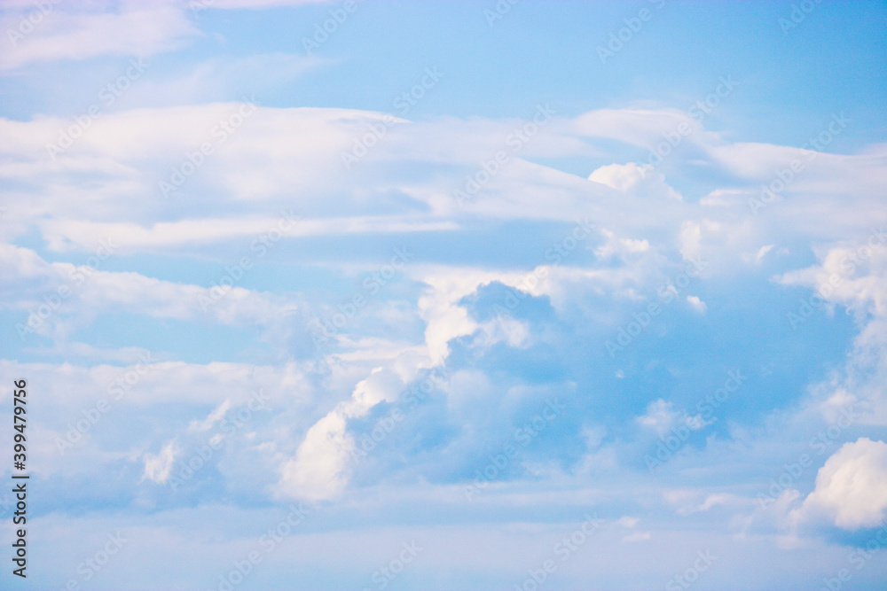 Cumulus and cirrus clouds in the blue sky. Atmospheric phenomenon, weather, summer. Cumulus and cirrus clouds in the blue sky. Atmospheric phenomenon, weather, summer.