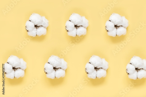White cotton on yellow background. Flat lay. Pattern