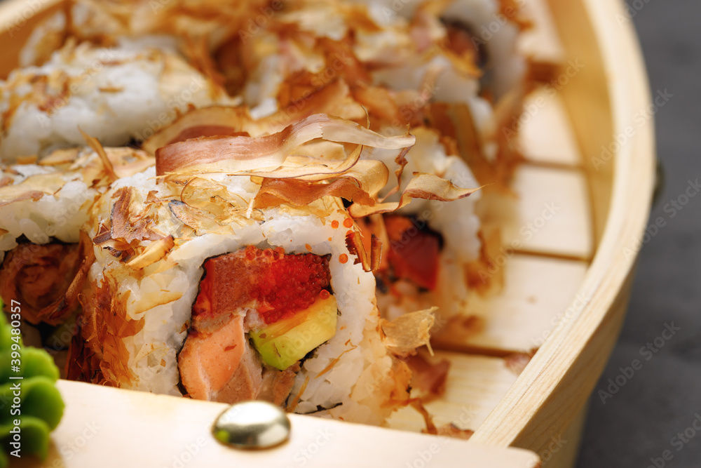 Sushi roll with tuna shavings on plate close up Sushi roll with tuna shavings on plate close up
