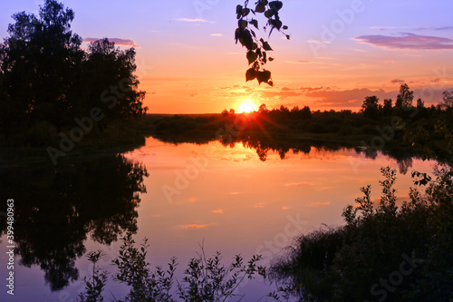 Colorful sunset over the river. Calm summer landscape. © ss404045