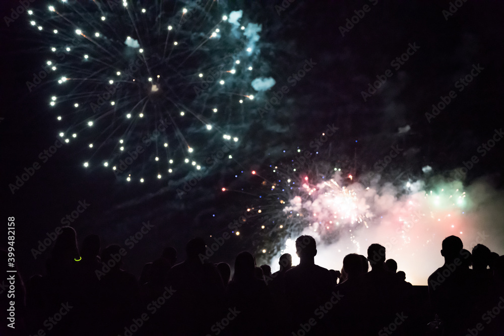 New year concept - cheering crowd and fireworks New year concept - cheering crowd and fireworks