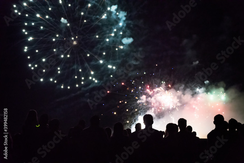 New year concept - cheering crowd and fireworks