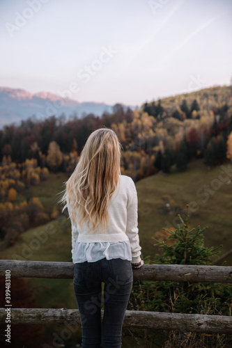 Beauty young blonde girl outdoors enjoying nature in autumn season. Active lifestyle concept.