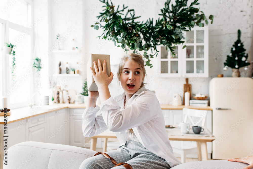 girl holding a gift in her hands, happy, emotions, new year and Christmas girl holding a gift in her hands, happy, emotions, new year and Christmas