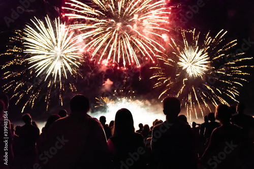 Crowd watching fireworks and celebrating new year eve photo