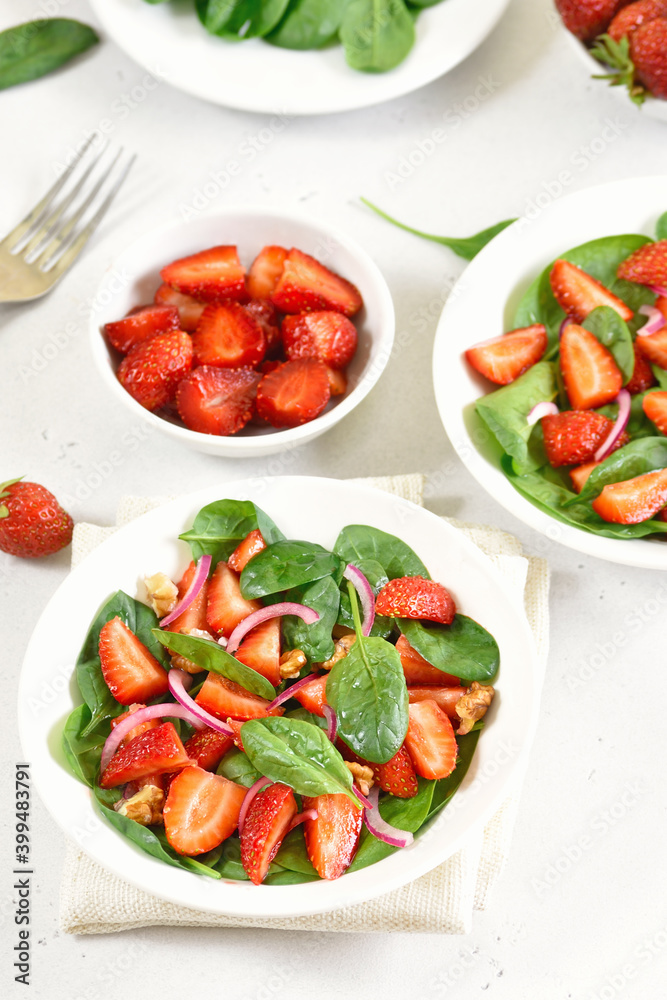 Healthy breakfast with fruit salad from strawberry, spinach and walnut