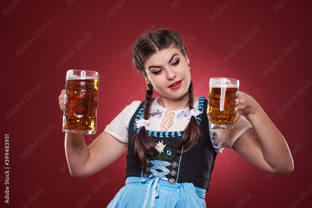 Young woman in traditional costume holding beer