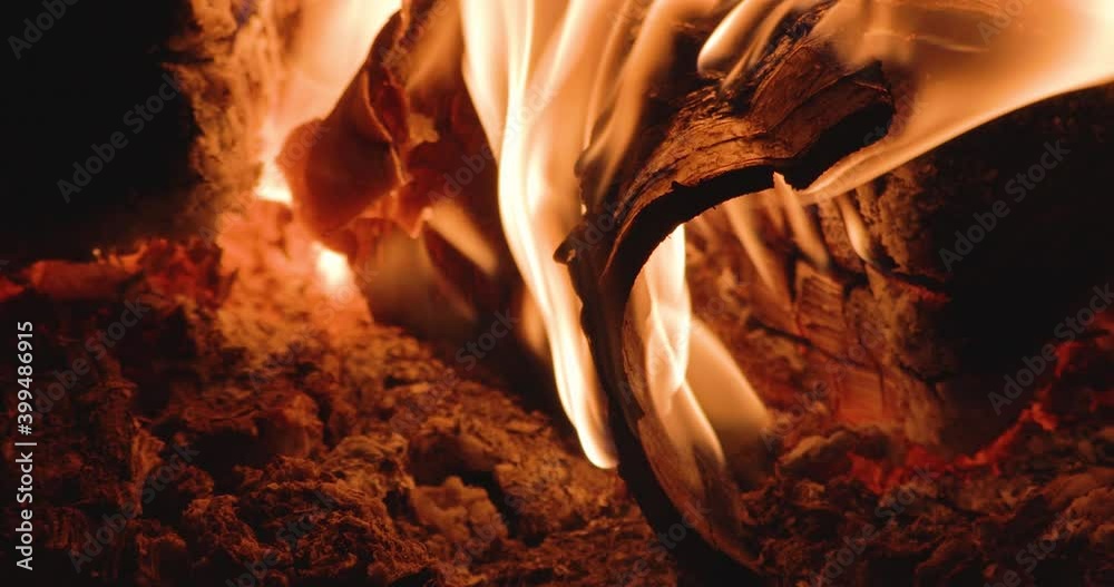 Birch bark burns in a village stove. Bright fire and soft focus Stock