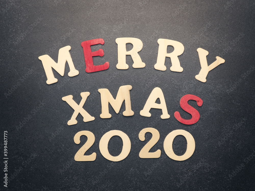 Fototapeta premium The words Merry Xmas 2020 on a chalkboard