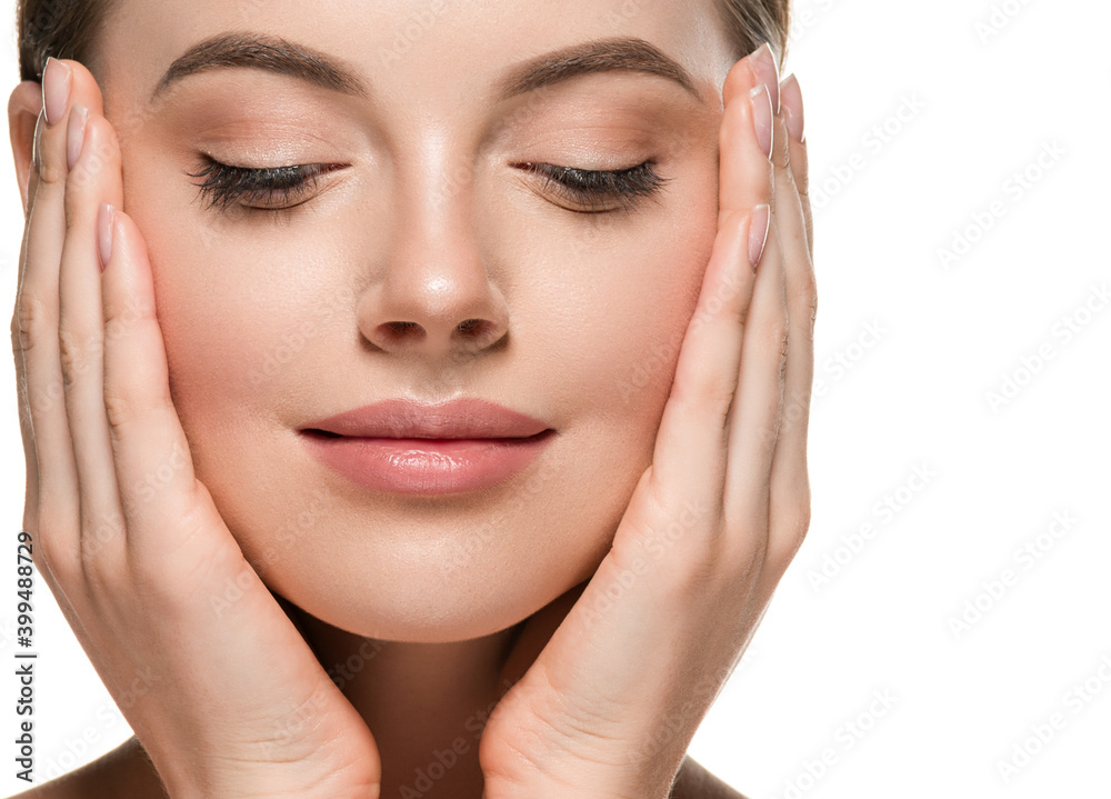 Beautiful woman face hands touching cheeks with healthy clean beauty skin close up