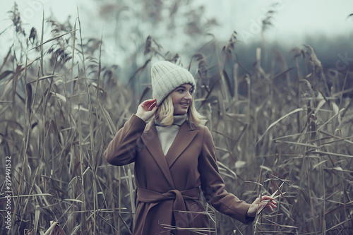 autumn fashionable portrait romantic girl in grass, travel seasonal look
