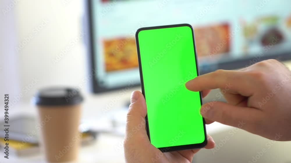 Handheld Camera: Back View of Brunette Man Holding Chroma Key Green Screen Smartphone Watching Content Without Touching or Swiping. Boy Using Mobile Phone, Browsing Internet, Watching Content, Handheld Camera: Back View of Brunette Man Holding Chroma Key Green Screen Smartphone Watching Content Without Touching or Swiping. Boy Using Mobile Phone, Browsing Internet, Watching Content,