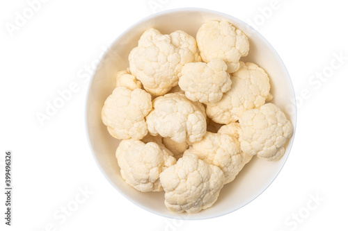 Pieces of cauliflower in the bowl isolated on white background, top view.