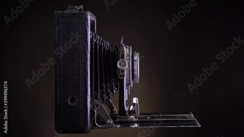 Timelapse  old antique photo camera shooting. Isolated on black background. Vintage object. photo