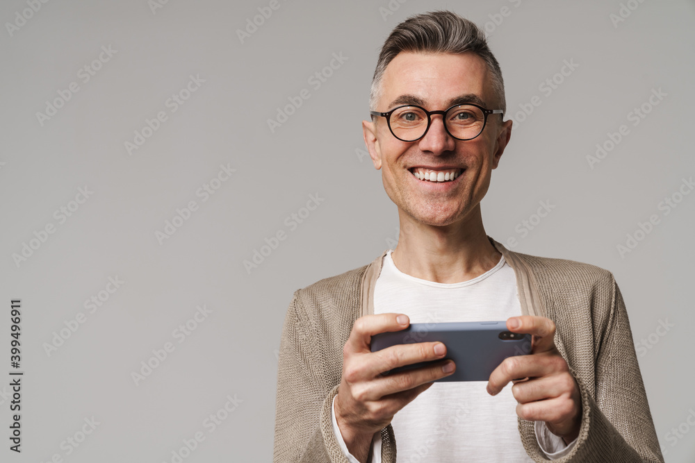 Portrait of an excited smart looking man playing games