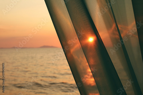 Photography The Bright Sun Shining Through the Curtain with Blurry Sea in Background