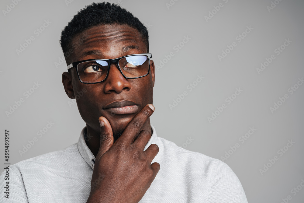 Closeup portrait of young african man thinking deeply Closeup portrait of young african man thinking deeply