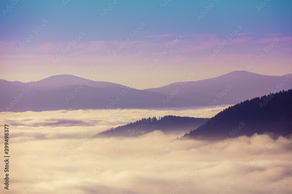Fantastic view of the tops of the mountain ridge above the clouds