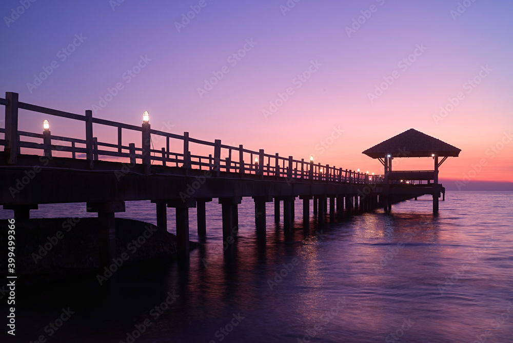 Silhouette of wooden pier with pavilion at the gorgeous dusk Silhouette of wooden pier with pavilion at the gorgeous dusk