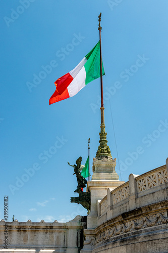italian flag in the center of rome. a large italian flag flies on a flagpole