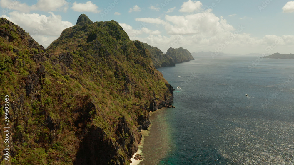 Bay and the tropical islands. Seascape with tropical rocky islands, ocean blue wate, aerial view. islands and mountains covered with tropical forest. El nido, Philippines, Palawan. Tropical Mountain