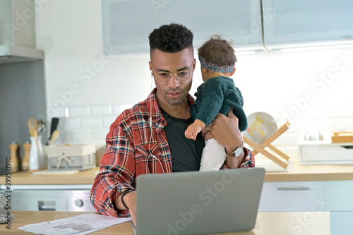 Daddy with babygirl teleworking from home during lockdown