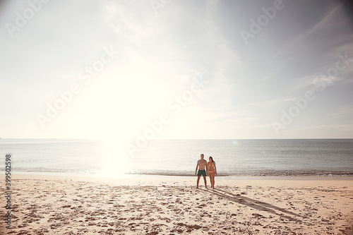 beach sea lovers / guy and girl relaxing in the summer on the sea coast, the concept of summer holidays, a vacation at sea