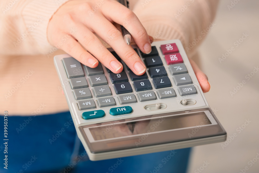 Female accountant with calculator in office, closeup Female accountant with calculator in office, closeup