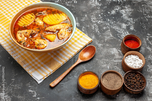 Side view of mouth-watering chicken soup five various spices and spoon photo