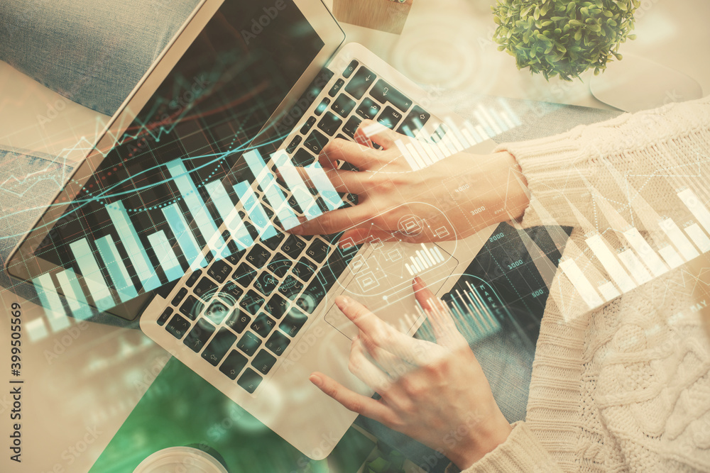 Double exposure of woman hands working on computer and forex chart hologram drawing. Top View. Financial analysis concept. Double exposure of woman hands working on computer and forex chart hologram drawing. Top View. Financial analysis concept.