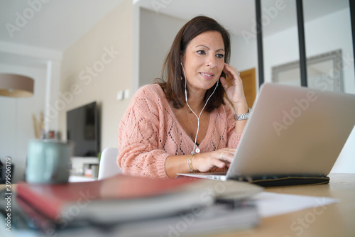 young brunette latin woman working on laptop at home