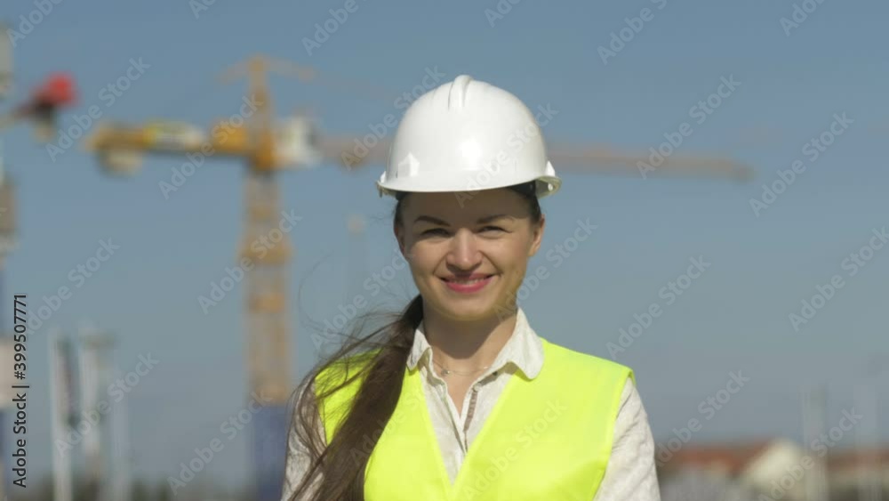 Girl builder in protective clothes at construction site. Girl builder in protective clothes at construction site.