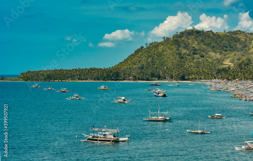 Coastal area facing the Sulu sea-Culipapa barangay of Hinoba-an, in Negros occidental, Philippines. Multiple fishing boats are anchored near the shoreline. The coast faces the Sulu Sea.