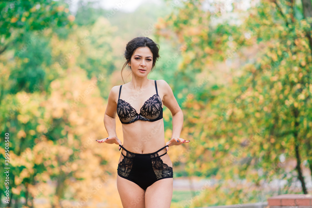 Beautiful young woman in lingerie in autumn forest Beautiful young woman in lingerie in autumn forest