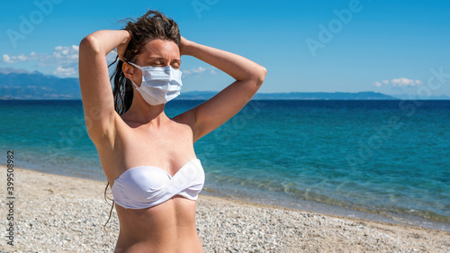 Woman in mask on a beach, Asprovalta, Greece photo