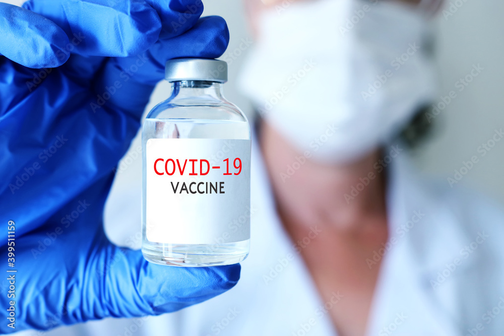 Doctor or nurse holding covid 19 vaccine. Healthcare and Medical concept Doctor or nurse holding covid 19 vaccine. Healthcare and Medical concept