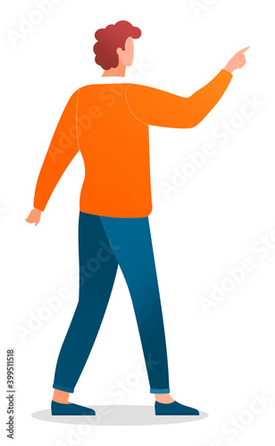 Young man caucasian with red curly hair standing at full height making a pointing gesture with finger. Guy in blue jeans and orange sweater on white background. A person pays attention to something