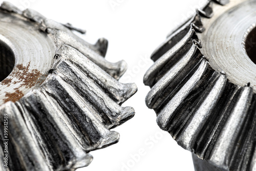 Quadro em tela Macro shot of a two damaged bevel gears with beveled teeth, isolated on a white background