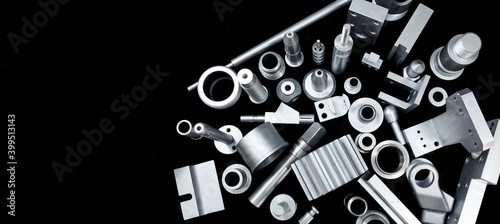 Shiny steel parts on a black background. Regular industrial metal production pattern.