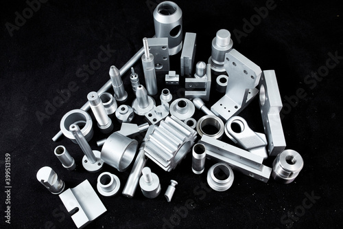 Shiny steel parts on a black background. Regular industrial metal production pattern.