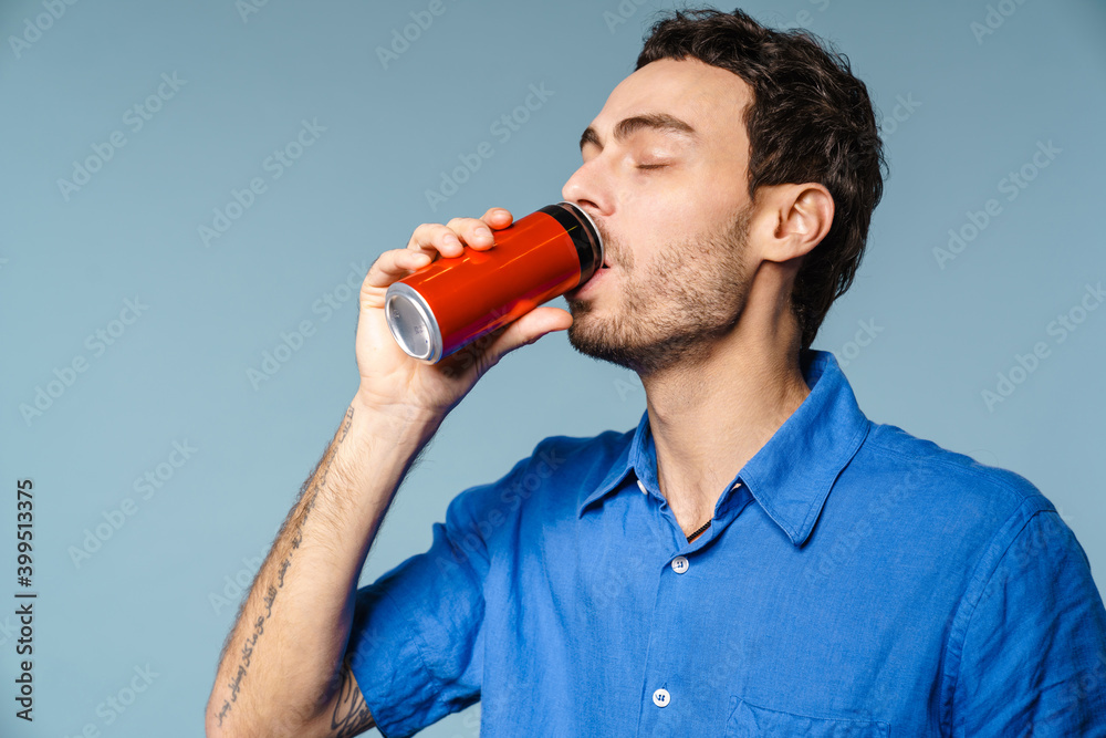 Happy handsome guy drinking soda with eyes closed Happy handsome guy drinking soda with eyes closed