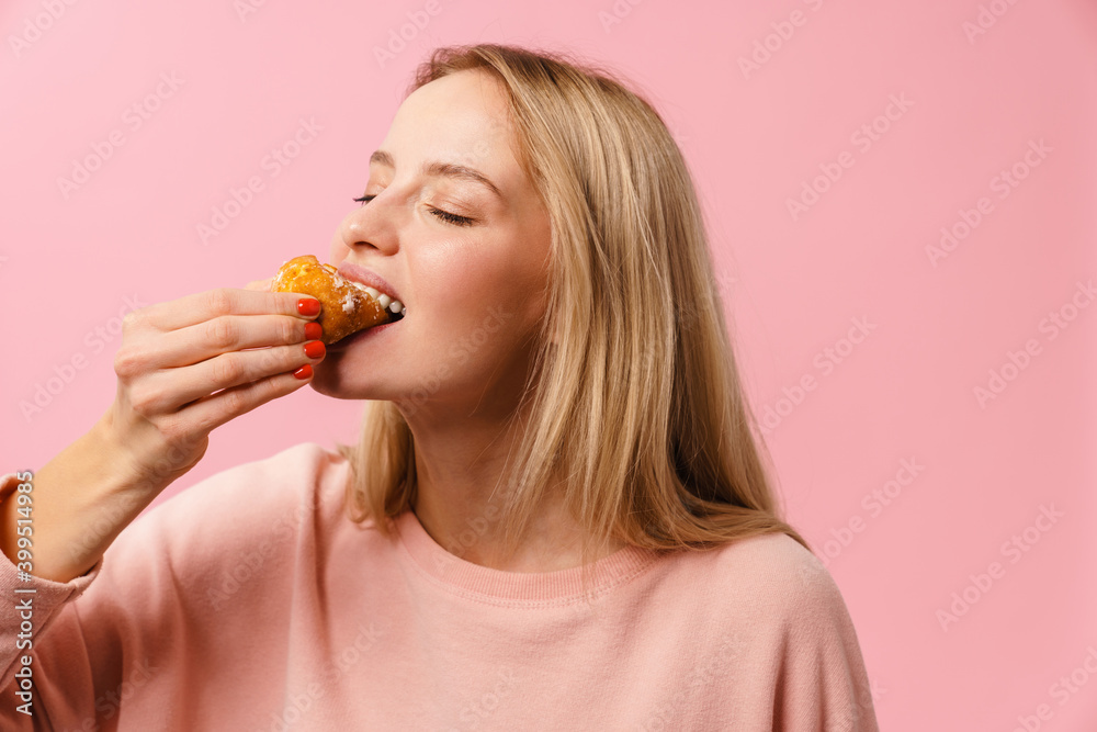 Happy charming blonde girl eating doughnut on camera Happy charming blonde girl eating doughnut on camera