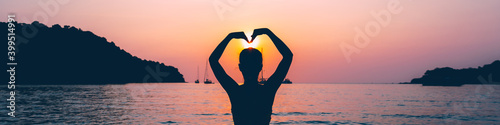 Silhouette of Travel asian woman relax on sea beach in sunset at Thailand