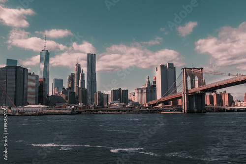 View of the New York City  with the Brooklyn Bridge over the river.