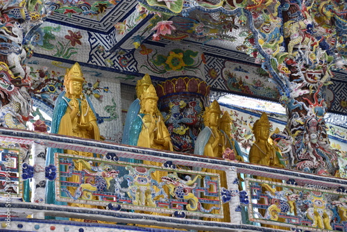 Golden Buddha Statues Standing in Karana Mudra on Balcony, Linh Phuoc Pagoda, Da Lat, Vietnam photo