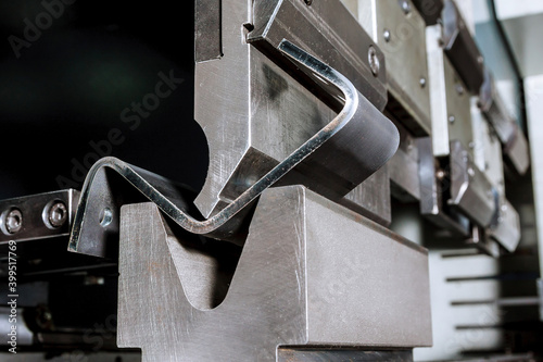 Photo The process of bending sheet metal on a hydraulic bending machine